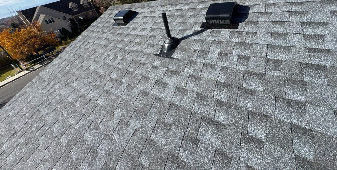Close-up of a new pipe jack flashing and turtle vents on GAF Timberline HDZ shingles in Orem