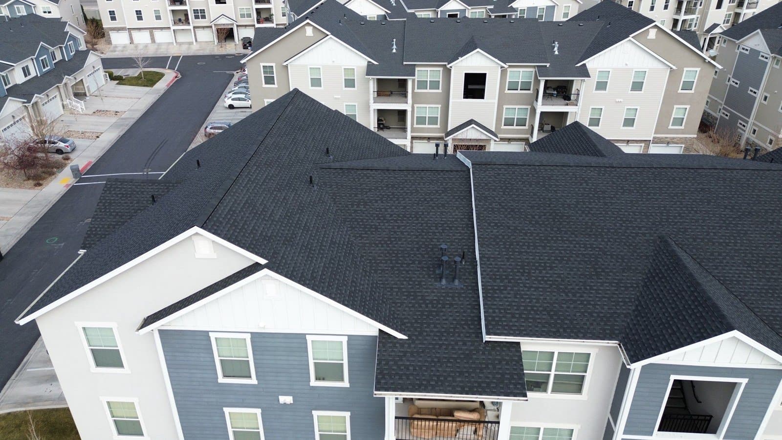 Aerial view of a finished Charcoal Timberline HDZ roof on Building A at Preserve at Waters Edge, December 2025